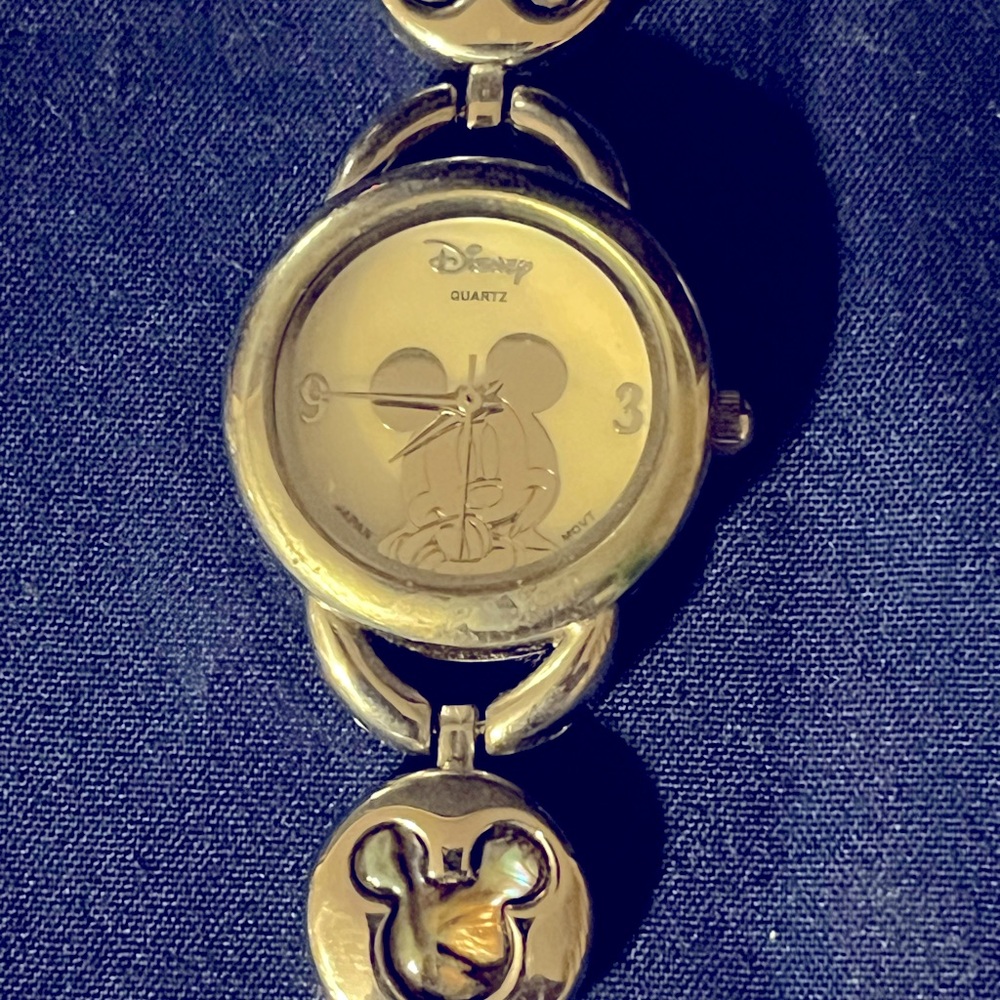 Mickey Mouse woman’s silver tone bracelet watch gently used needs battery.